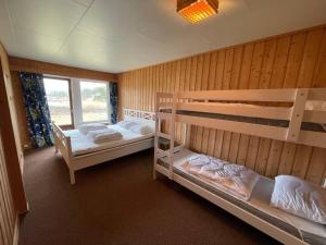 a bedroom with two bunk beds and a window at Summer house on Tjøme with beach and pier in Tjøme