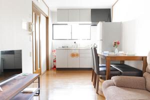 a kitchen with a table and a dining room at 悠の宿 in Osaka