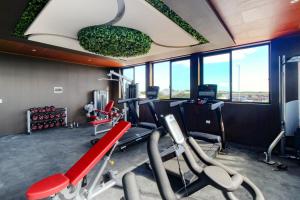 a fitness room with a gym with tread machines at Menesse Tulum #327, Downtown in Tulum