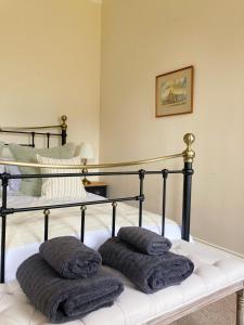a bedroom with a bed with two pillows on it at Meldon Cottage in Morpeth, Northumberland in Morpeth