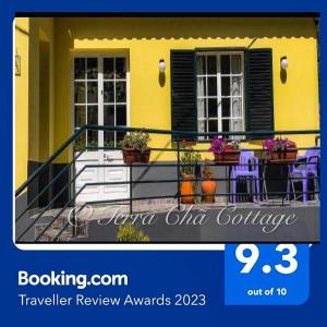 a picture of a yellow house with a balcony at Terra Chã Cottage,FEEL Home, in São Vicente