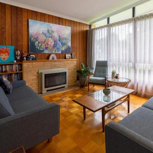 a living room with two couches and a fireplace at Jamaica Mid-Century in Seaton +36 photos