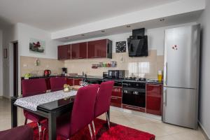 a kitchen with a table and a refrigerator at Val in Kaštela
