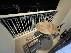 a table and a chair on a balcony with a view at Teega Suites #3101 Puteri Harbour Iskandar Puteri in Nusajaya