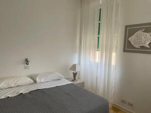 Postel nebo postele na pokoji v ubytování SEABAUDIA1 CON TERRAZZA