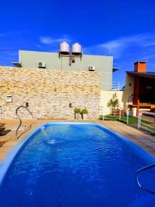 une grande piscine bleue avec une fontaine dans l'établissement Complejo Amarelo, à Chajarí
