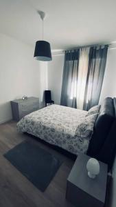 a bedroom with a bed and a couch and a table at Sun Street Apartment in Verona