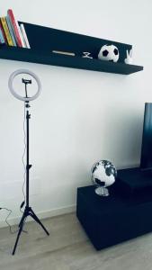 a room with a desk with a soccer ball and a lamp at Sun Street Apartment in Verona