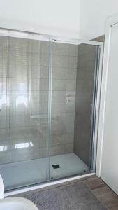 a shower with a glass door in a bathroom at Sun Street Apartment in Verona