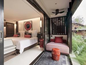 a hotel room with two beds and a balcony at Aleenta Retreat Chiang Mai in Chiang Mai