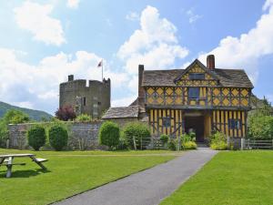 an old building with a castle and a picnic table at Walnut Tree Cottage in Bucknell
