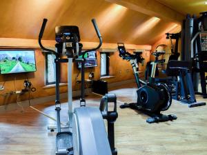 a gym with several exercise bikes and a tv at The Hayloft - Igp in Glaisdale