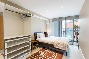 ロンドンにあるDuplex Two-Bed Apartment Near Tower Bridgeのベッドルーム1室(ベッド1台、大きな窓付)