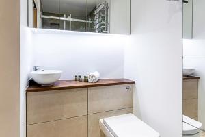a bathroom with a sink and a toilet at Duplex Two-Bed Apartment Near Tower Bridge in London