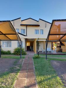 a view of a house with two shade structures at Complejo Amarelo in Chajarí