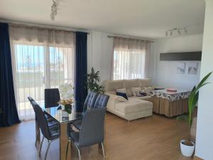 a living room with a table and a couch at Niza Beach Sunset Stay in Málaga +23 photos