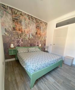 a bedroom with a green bed and a wall at Col di Lana in Cagliari