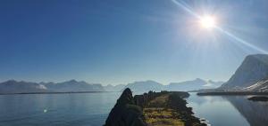 a view of a body of water with mountains in the background at Lofoten Sunset Large Appartments in Valle