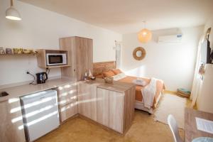 a small kitchen with a bed and a microwave at ESPACIO RAKU in Ciudad Lujan de Cuyo