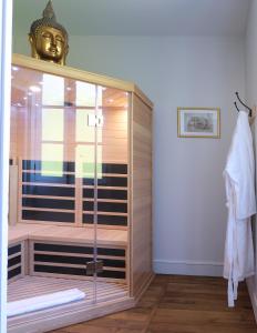 a shower with a glass door in a bathroom at Château de Crespy & Suites 