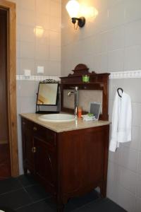 a bathroom with a sink and a mirror at Quinta do Toutuço in Arouca