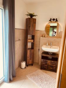 a bathroom with a sink and a mirror at Hotel Zum Alten Schlagbaum, Garni in Wegberg