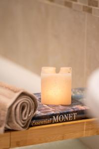 a candle sitting on top of a book at Cottage Apartment in Dunblane