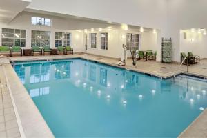 a large pool with blue water in a hotel at Residence Inn by Marriott Chicago Schaumburg/Woodfield Mall in Schaumburg