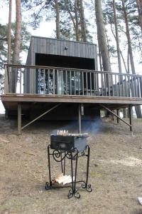 a house with a grill in front of it at Little Amber in Bernāti