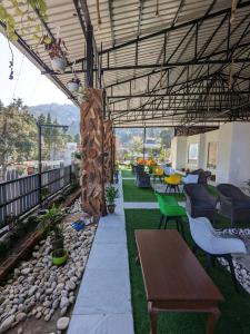 an outdoor patio with tables and chairs and a table at The 9 Oaks by BOP group of Stay and Cafe in Mussoorie