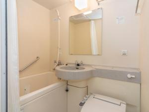 a small bathroom with a sink and a toilet at APA Hotel Kobe-Sannomiya in Kobe