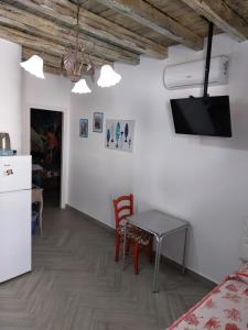 a kitchen and dining room with a table and a refrigerator at Villa Salvatore in San Leone