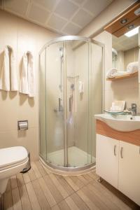 a bathroom with a shower and a toilet at Arbatt Marmaris Hotel in Marmaris