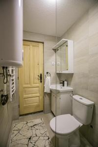 a bathroom with a toilet and a sink and a door at Nicola’s hill in Žabljak +47 photos