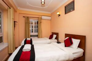 Una cama o camas en una habitación de Hotel Mudkhu Durbar