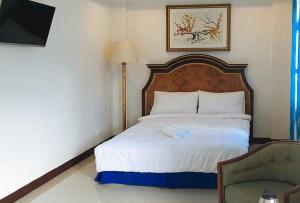 sypialnia z łóżkiem, lampką i krzesłem w obiekcie RedDoorz at Caree Boutique Hotel Bulan Sorsogon w mieście Bulan