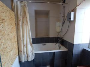 a bath tub in a bathroom with a shower curtain at Sun city hostel in Yerevan