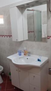 a bathroom with a white sink and a mirror at Apartment Sevid in Sevid +13 photos