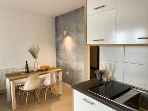 a kitchen with a table and chairs in a room at Portview apartment in Rijeka