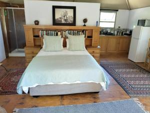 a bedroom with a large bed in a kitchen at Glamping at The Well in Franschhoek in Franschhoek