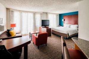 a hotel room with a bed and a desk and chairs at Residence Inn San Ramon in San Ramon