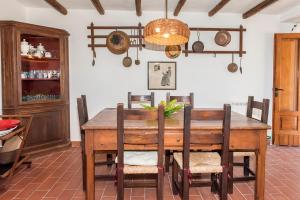 a dining room with a wooden table and chairs at Casale della Luna in Ancona