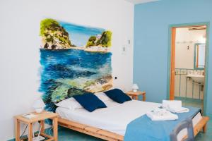 a bedroom with a bed and a painting on the wall at Casetta Giulia in Procida