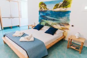 a bedroom with a bed and a painting on the wall at Casetta Giulia in Procida