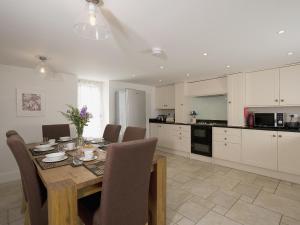 a kitchen with a wooden table with chairs and a dining room at North Range in Castleton
