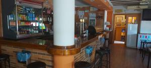 a bar in a restaurant with stools at Hostal San Julian in El Herrumblar +8 photos