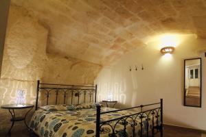 Postel nebo postele na pokoji v ubytování Stay Matera nei Sassi