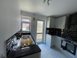 a kitchen with a sink and a counter top at Lovely 2 bedroom apartment with a garden in Royal Tunbridge Wells