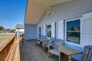 a porch with two chairs and a bench on it at Beach Bliss in Kill Devil Hills