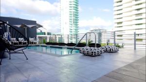 a balcony with a swing and a pool on a building at 6080 Design Hotel by Eskape Collection in Miami Beach +63 photos